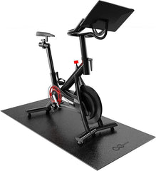 Bike mat compatible with Peloton bike, shown under a stationary spin bike on hardwood floor. 6mm thick mat protects carpet and flooring from damage.