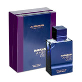 A blue and purple box and perfume bottle with gold text, from Showlu Well Nation Store. The Al Haramain Amber Oud Dubai Night Edition Extrait de Parfum (60ml) features a square cap, metallic finish, and is chemical-free for a luxurious experience.