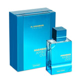 A blue Al Haramain Amber Oud Aqua Dubai Extrait de Parfum (60ml) bottle from Showlu Well Nation Store stands beside a matching box labeled "AL HARAMAIN SINCE 1970" and "AE Origin.