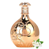 The ARABIYAT Nyla Unisex Arab Perfume (80ml) from Showlu Well Nation Store features a reflective gold bottle with ornate swirls, standing upright beside white jasmine flowers and green leaves, symbolizing its long-lasting scent for all.