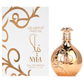 A gold, ornately designed bottle stands beside a white and gold box labeled ARABIYAT Nyla Unisex Arab Perfume 80ml by Showlu Well Nation Store, featuring long-lasting woody notes and exquisite gold decorative patterns.