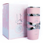 A pink bottle of Showlu Well Nation Store Lattafa Yara Vanilla Gourmand Fruity Floral Eau De Parfum for women (100ml) stands by its matching box, both with decorative accents and Arabic script.