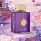 A purple Armaf Club De Nuit Maleka Pheromone Fragrance bottle from Showlu Well Nation Store with a gold cap stands on a pastel platform, perfect for those seeking an alluring Arabian women’s perfume against pink and purple shimmering water.