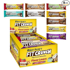 A yellow box of Showlu Well Nation Store's FITCRUNCH Snack Size Protein Bars, 6-Layer Baked Bar (Flavor Lovers, 9 count), is displayed with vibrant packaging highlighting its gluten-free, low sugar, soft cake core snacks.