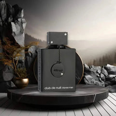 Black rectangular bottle of Original 3.6 Oz/105ML Arab Perfume men's cologne with minimalist design on a round platform and rocky background