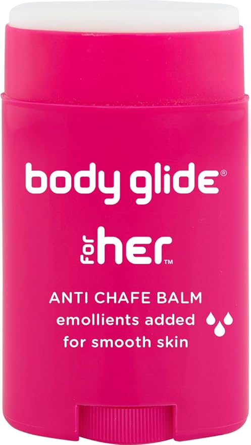 A pink stick of Body Glide For Her Anti Chafe Balm with white text notes added emollients for hydration and moisture retention; designed for dry, sensitive skin and areas prone to chafing—chest, bra line, butt, groin, arms, and thighs. 1.5oz.