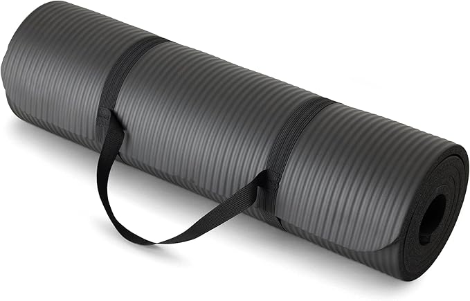 The Showlu Well Nation Store 1/2 Inch Extra Thick Exercise Yoga Mat, featuring a textured surface and black carrying strap, offers cushioned support for fitness and gym workouts; shown rolled up on a white background.