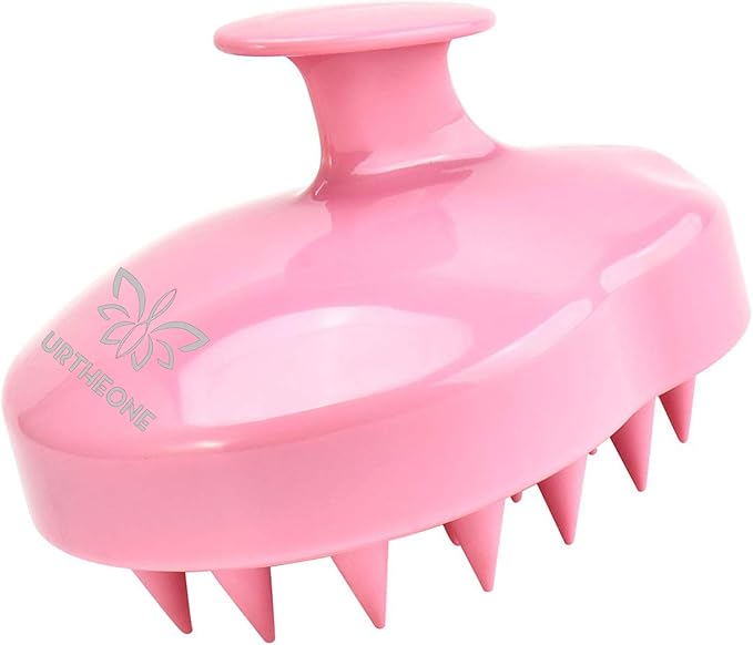 The URTHEONE Soft Silicone Hair Scalp Massager Shampoo Brush (Pink) features flexible bristles and a top handle for easy grip. Perfect for all hair types, it relieves dandruff and itchiness. The URTHEONE logo is printed on the side.