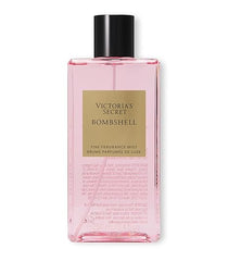 A rectangular clear pink 8.4oz bottle of Bombshell Fine Fragrance Mist by Showlu Well Nation Store, with a black cap and gold label, features the product name and delivers a signature fruity floral scent.
