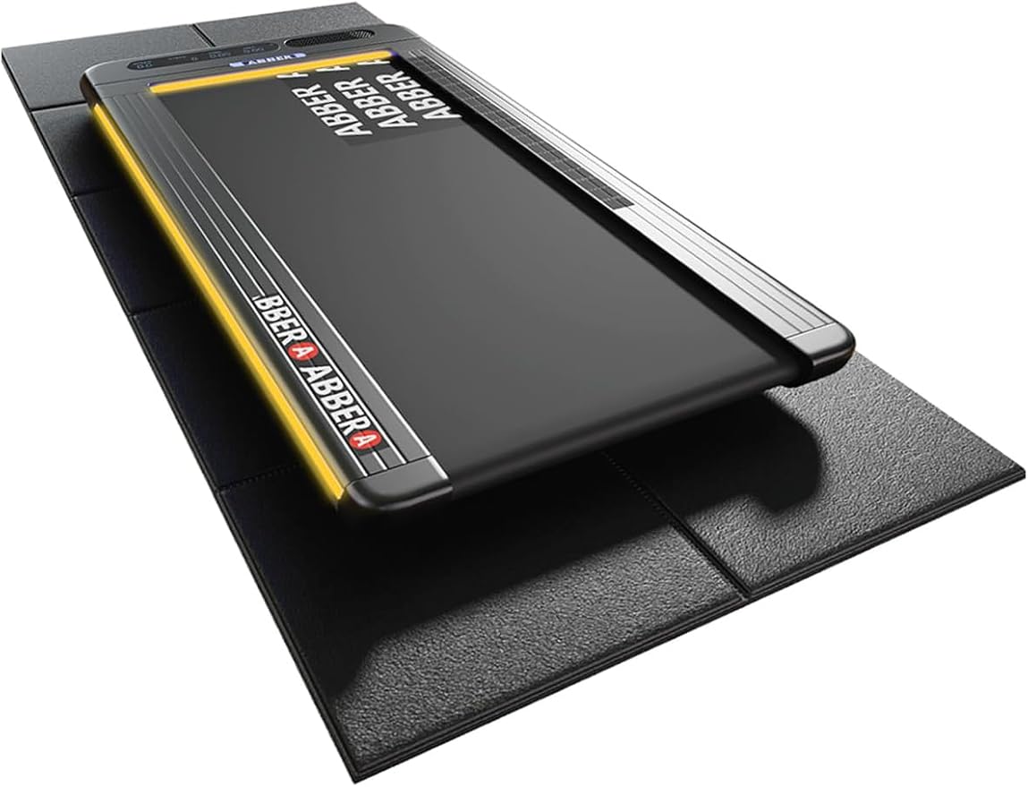 63"x30" walking pad mat placed under a compact treadmill on carpet flooring, designed for hardwood floor protection and compatible with Peloton equipment.