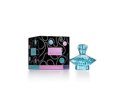 A light blue, gem-shaped bottle of Showlu Well Nation Store's Curious Eau De Parfum EDP Spray for Women (3.3 Fl Oz) sits beside a black box with colorful circles and swirling lines, labeled as a white floral scent.