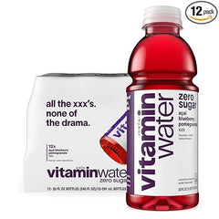A bottle of vitaminwater XXX Acai-Blueberry-Pomegranate Zero Sugar sits beside its 12-pack box, labeled "all the xxxs. none of the drama," highlighting this zero sugar, antioxidant drink’s naturally sweet flavor.
