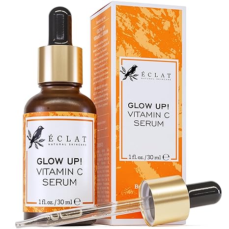 A bottle of Eclat Skincare Vitamin C Serum for face, with hyaluronic acid, ferulic acid, and vitamin E—an anti-aging and skin-brightening formula for dark spots—shown with dropper and orange-white box packaging. 1 fl oz size.