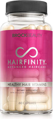 A clear bottle of Hairfinity Hair Vitamins (60 vegan capsules) with a pink and white label, scientifically formulated with biotin, amino acids, and vitamins to help support hair growth for healthier locks.