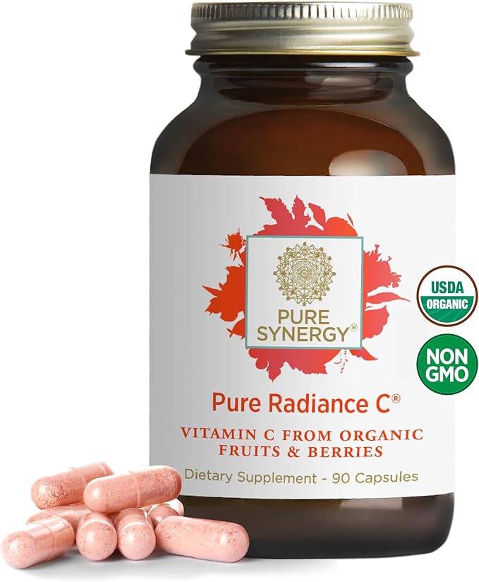 A bottle of PURE SYNERGY Pure Radiance C contains 90 organic vitamin C capsules with camu camu for immune and collagen support. The label notes whole food, non-GMO ingredients. Several pink capsules are shown next to the bottle.