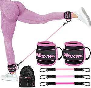 A person in pink leggings demonstrates leg exercises using Ankle Resistance Bands with Cuffs, which come with adjustable ankle cuffs, pink and black bands, and a mesh bag—ideal booty workout equipment for hip fitness and butt lift training.
