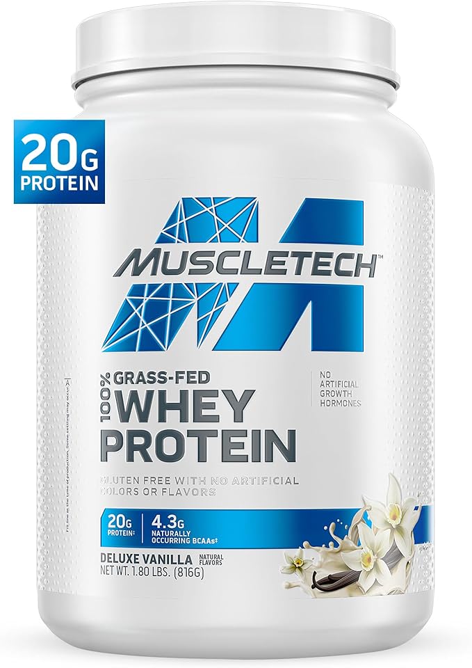 A white container of Muscletech Grass-Fed Whey Protein Powder (Deluxe Vanilla, 1.8LB) offers 20g protein per serving to support muscle gain and recovery. It’s non-GMO, gluten-free, has no artificial colors or flavors, with vanilla flowers on the label.