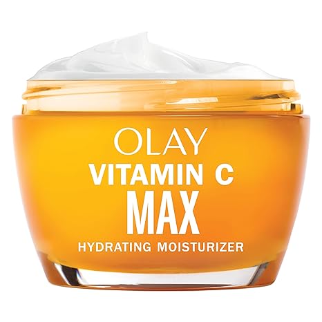 An open orange jar of Olay Vitamin C MAX Face Moisturizer reveals white cream inside. This hydrating cream for women with niacinamide and peptides helps brighten skin, even tone, and reduce dark spots. Product details are printed in white on the jar.