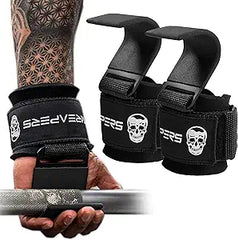A tattooed arm grips a barbell using black Gymreapers Weight Lifting Hooks with a skull logo and metal hook; the matching pair rests nearby.