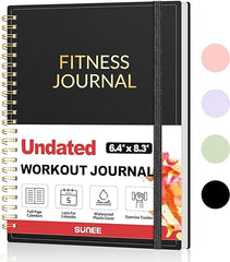 The Fitness Journal Workout Planner for Women & Men (A5, black) features a waterproof cover, gold text, and icons for its workout calendar and exercise tracker. Three pastel color circles are shown beside this undated, spiral-bound log book.