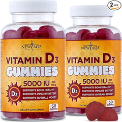 Two bottles of NEW AGE Vitamin D3 5000 IU gummies (120 total, pack of 2), non-GMO, gluten- and dairy-free. Labels highlight immune support, bone health, mood benefits. Red gummies inside; 2-pack icon is at the top right.