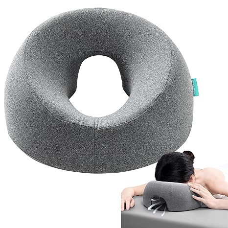 The gray Face Down Pillow with a removable cover is shown alone and in use, providing comfort and support as a person rests face down—ideal for massage tables, bed headrests, stomach sleeping, BBL recovery, post-eye surgery, or vitrectomy.