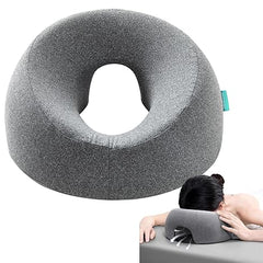 The gray Face Down Pillow with a removable cover is shown alone and in use, providing comfort and support as a person rests face down—ideal for massage tables, bed headrests, stomach sleeping, BBL recovery, post-eye surgery, or vitrectomy.