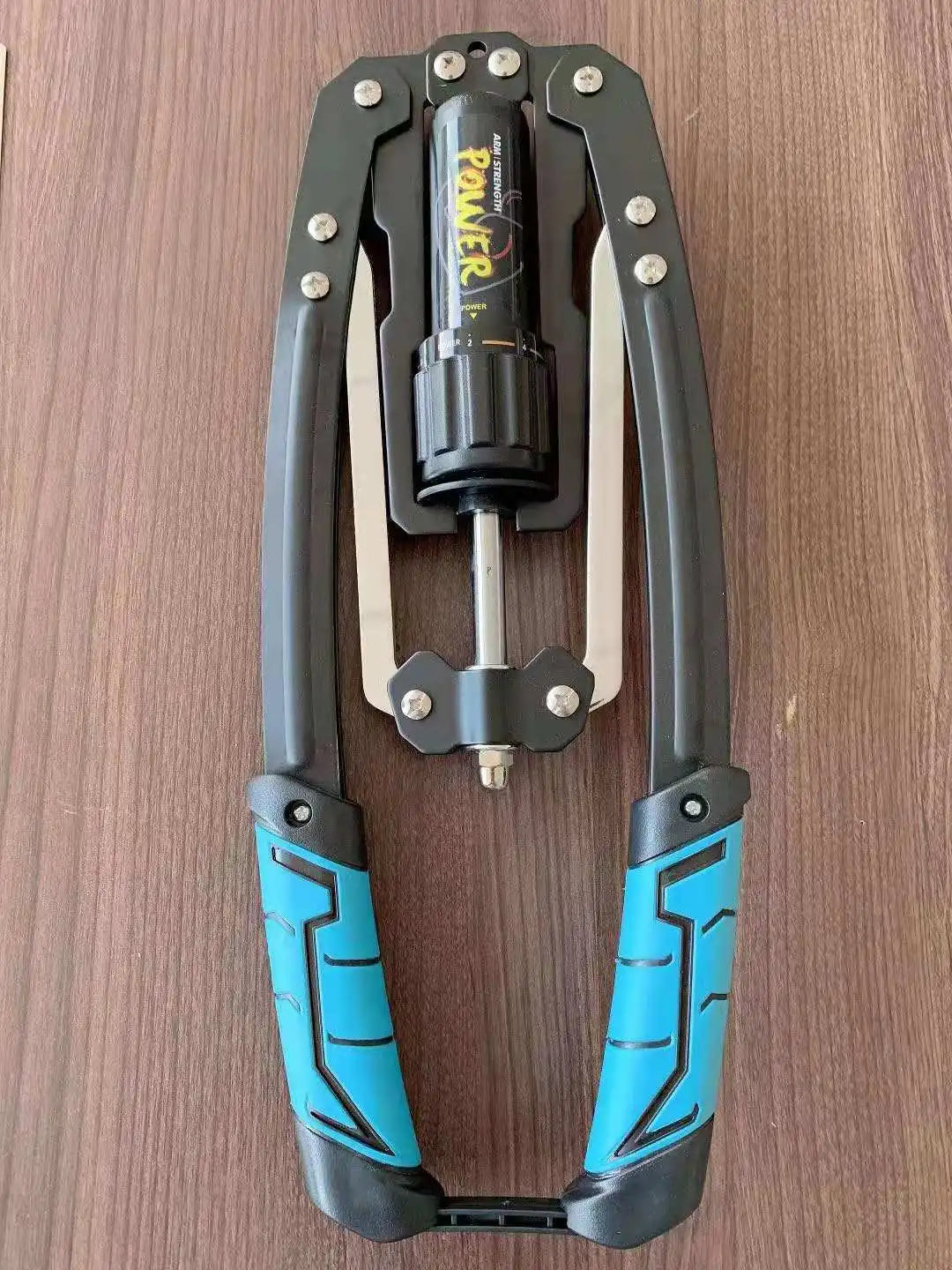 The Wellshow Hydraulic Power Home Chest Expander, adjustable from 22-440lbs, features blue and black padded handles and a central resistance dial—ideal as a Sport Twister Arm Exerciser for wrist, chest, and shoulder muscle workouts.