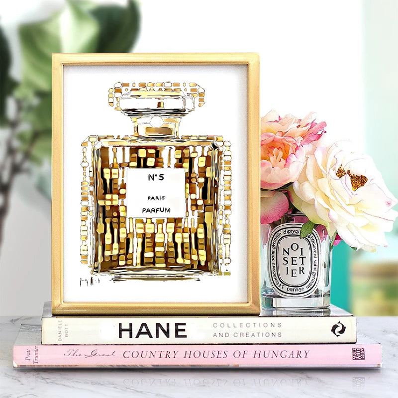 The Fashion Perfume Bottle Prints Nordic Poster features a chic perfume bottle on canvas, displayed with books, a candle, and florals—perfect luxurious wall art decor for bedroom or living room. Waterproof ink ensures lasting modern style.