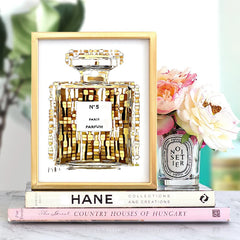 The Fashion Perfume Bottle Prints Nordic Poster features a chic perfume bottle on canvas, displayed with books, a candle, and florals—perfect luxurious wall art decor for bedroom or living room. Waterproof ink ensures lasting modern style.