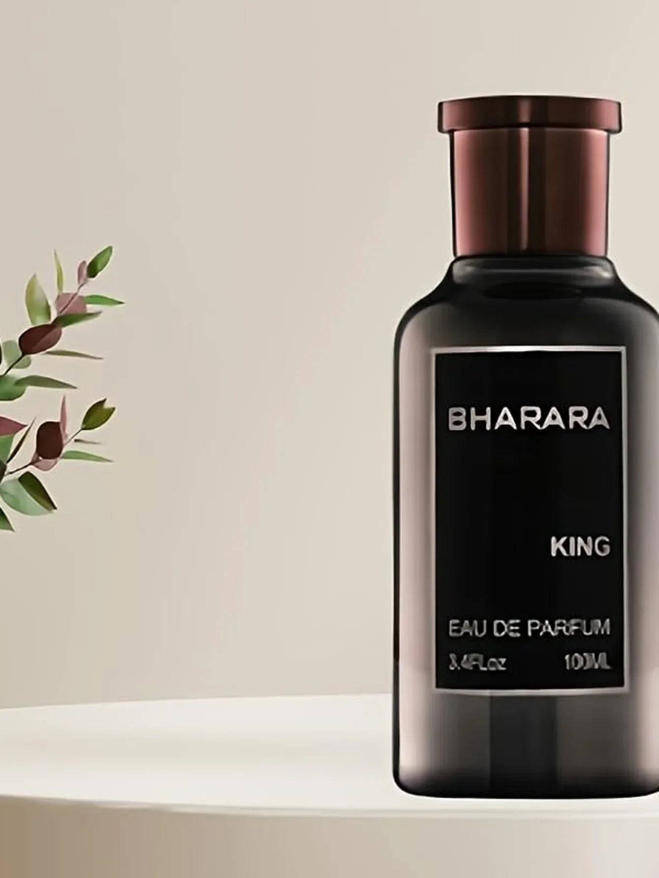 A dark bottle labeled Bharara King EDP 3.4oz, a bold woody amber men's cologne with a long-lasting luxury scent, stands on a white surface—perfect for evening wear—beside a leafy plant and neutral background; ideal holiday gift.