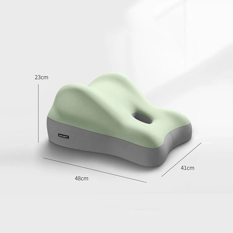 The Multi-Functional Ergonomic Bed Pillow is a light green and gray memory foam waist cushion with 100% cotton cover, contoured curves, central hole for support, and measures 48×41×23cm. Ideal as a tummy or wedge-shaped pillow for sitting comfort.