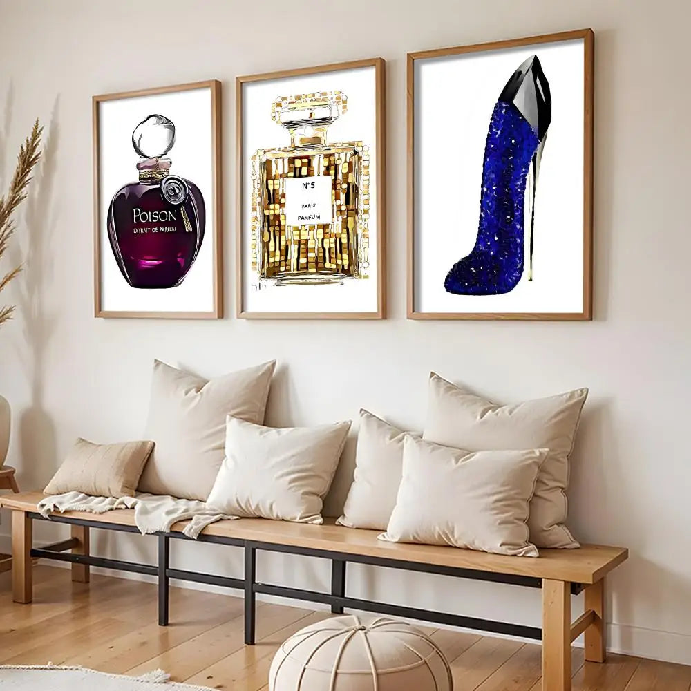 A modern living room with a wooden bench and cream pillows, featuring three Perfume Bottle Prints Nordic Poster Wall Art stickers: purple and gold perfume bottles, and a blue glittery high-heel shoe-shaped bottle.