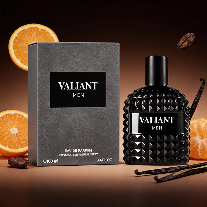 A bottle and box of 3.4 Fl Oz Men's and Women's Eau De Parfum are displayed against a dark background with orange slices, vanilla beans, and coffee beans. This unisex fragrance features mandarin orange, orange blossom, and bergamot notes.