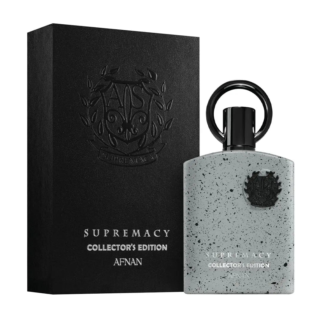 A gray speckled bottle of Afnan Supremacy Collector's Edition for Men Eau De Parfum (3.4 fl. oz) stands beside its matching black embossed box, both featuring the same bold branding.