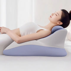 A woman relaxes on the Memory Foam Bed Wedge Pillow, featuring a blue and white design, enjoying head and back support for acid reflux relief, anti-snoring, pain relief, reading comfort, and post-surgery recovery in a bright setting.