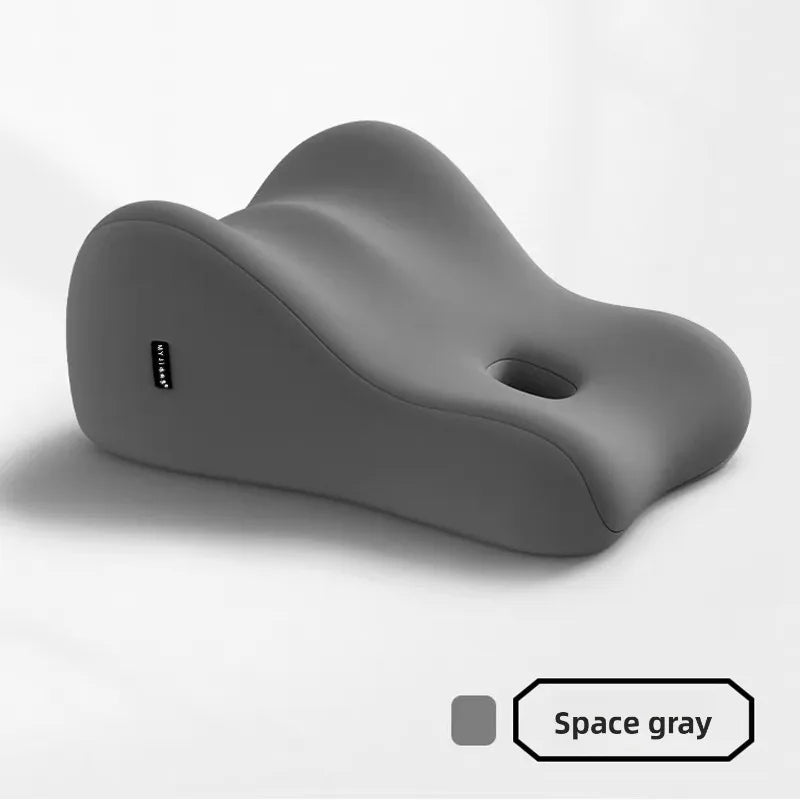 The Intimacy Support Wedge Pillow for Couples is a memory foam cushion in space gray, featuring ergonomic curves and a central hole for body support. Made in Mainland China, it includes a washable cover and displays "Space gray" with a matching swatch on its label.