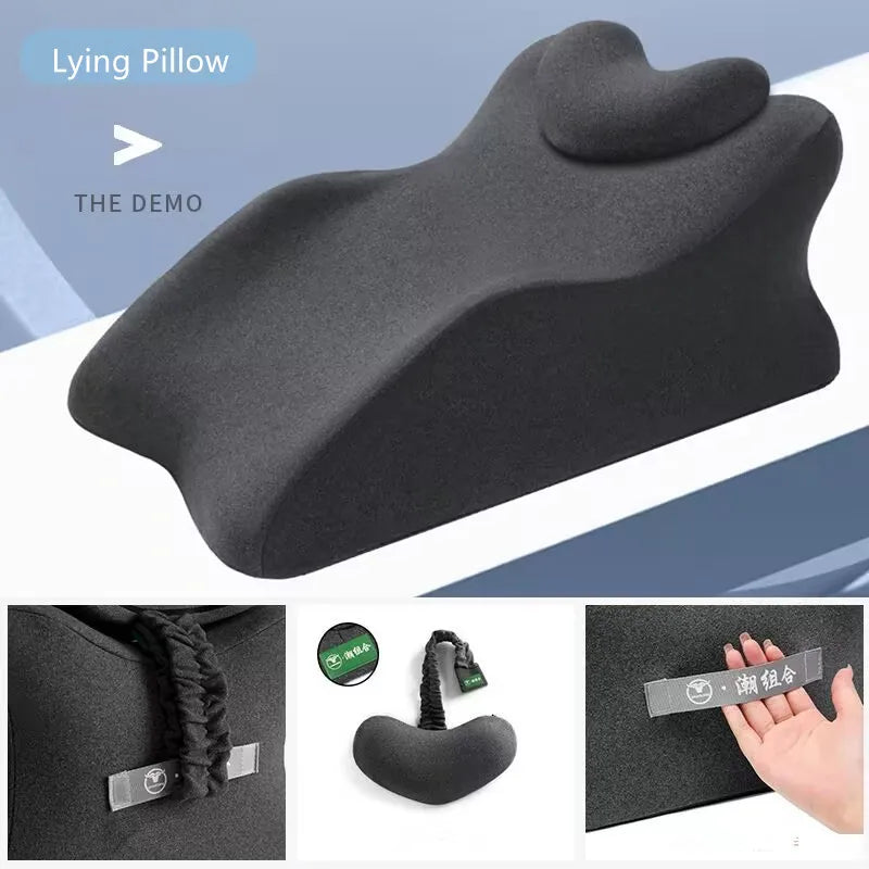 The Lie On The Bed Sleeping Pillow is a black, contoured memory foam cushion with a heart-shaped headrest. Below are close-ups of its 100% polyester texture, included drawstring bag, and a hand holding the fabric label.