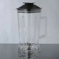 The For SILVER CREST Blender Spare Jug, a 2L transparent plastic replacement part with black lid and handle, made in Mainland China, sits on a reflective surface. Its metal blade is visible inside this portable blender jar.