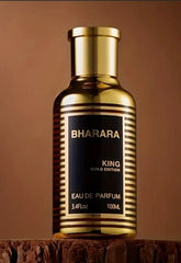 A 3.4 oz bottle of Bharara Men's Eau de Parfum, perfect as a holiday gift, stands on a wooden surface against a plain brown background.