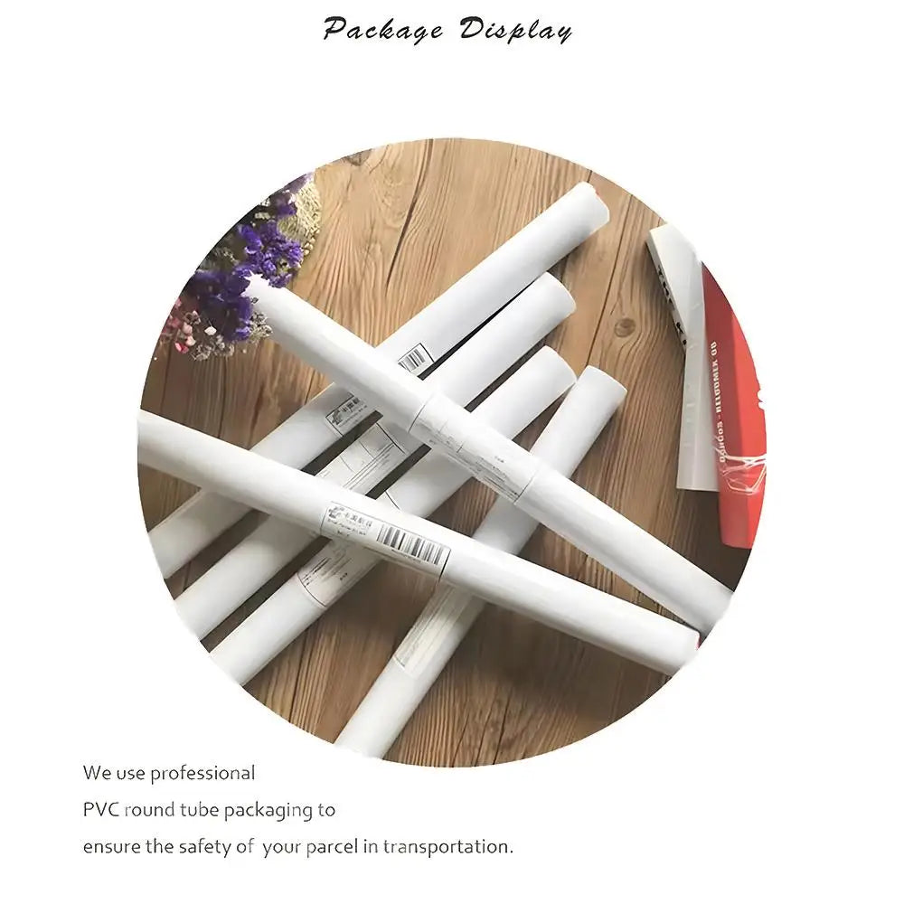 A set of Perfume Bottle Prints Nordic Poster Wall Art Stickers for home decor is rolled in clear PVC tubes on a wooden surface, with purple flowers and a red book nearby, showing safe PVC round tube packaging for parcel transport.