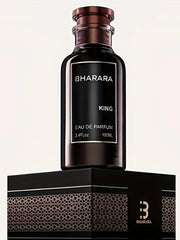 A dark brown bottle labeled Bharara King EDP 3.4oz, a bold woody amber men’s cologne with a long-lasting luxury scent, stands on a black and gold patterned box featuring a stylized B logo against a plain light background.