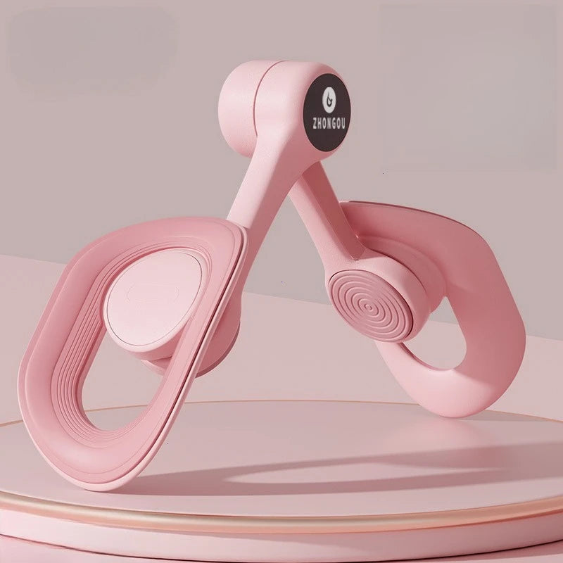 A pink Non-Slip Comfortable Pelvic Floor Muscle Trainer Thigh Exerciser with looped handles and spiral joints sits on a round pedestal against a soft pink background. The circular label reads ZHONGOU, emphasizing its innovative leg & butt training design.