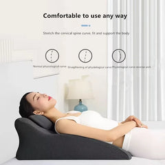 A woman in white reclines on the "Lie On The Bed Sleeping Pillow," a dark ergonomic memory foam wedge, with text above about spinal support and diagrams showing normal, straightened, and reverse-arched spine curves. The scene features minimal bedding.