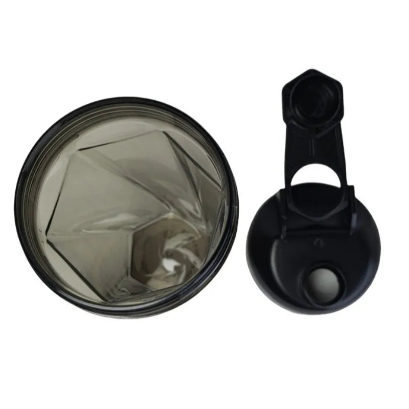 A top-down view of the 600ml Vortex Mixer Shaker Bottle made from high quality TRITAN material, featuring a geometric interior design and a black flip-cap lid placed to the right; ideal for protein shakes at the gym.