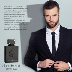 A well-groomed man in a suit adjusts his jacket beside a large bottle of Armaf Club De Nuit Intense Man eau de toilette, 3.6oz (102.1g), wood spicy, with fragrance description text highlighting this bold scent in the background.