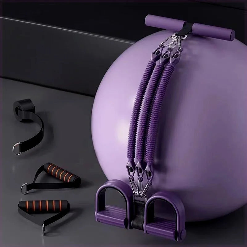The Pedal Tension Rope Abdominal Strength Elastic Rope, a multi-functional resistance band with handles and foot pedals, rests beside a large purple exercise ball, offering versatile fitness and muscle relaxation options.