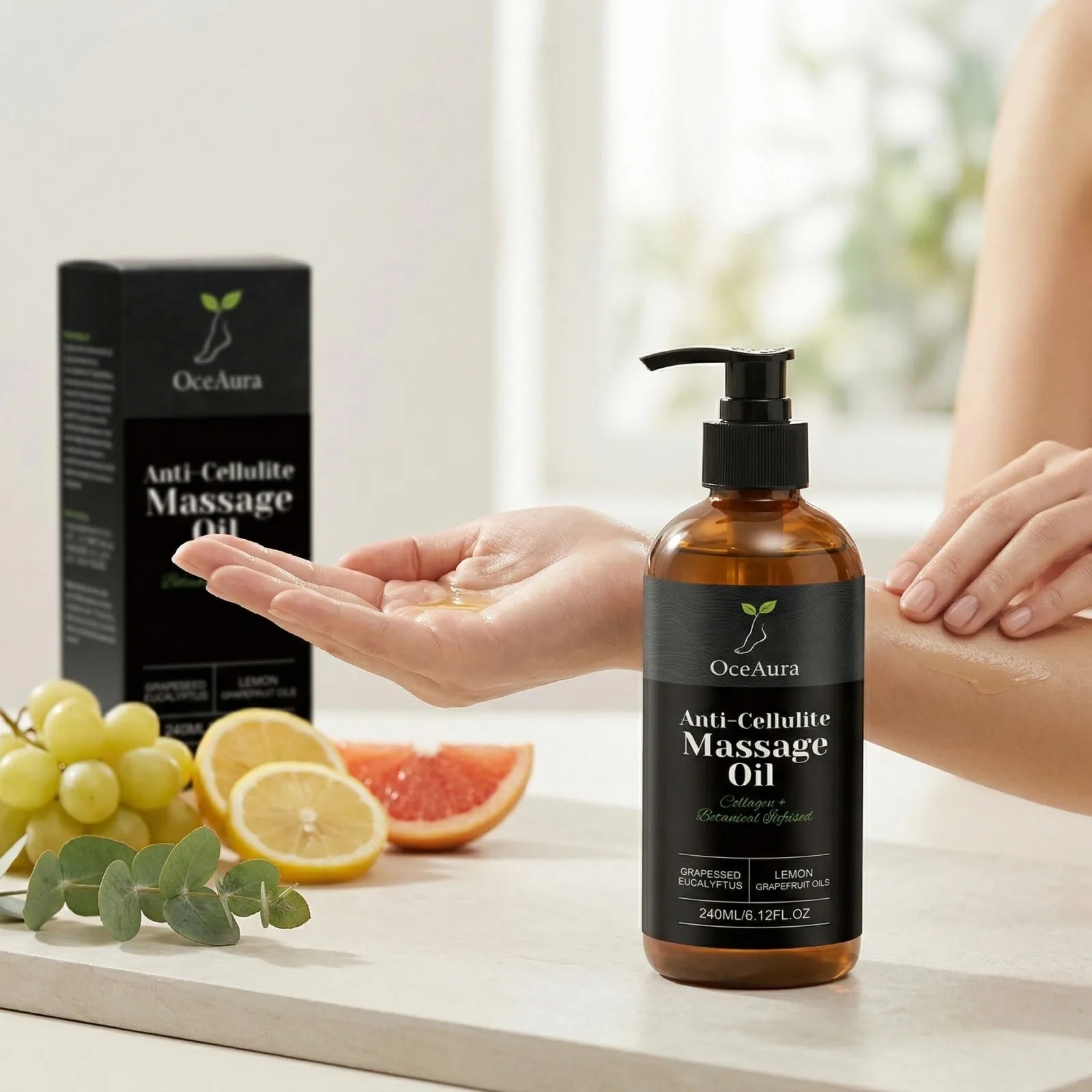 A hand dispenses Anti Cellulite Oil Firm Skin Tightening Massage Oil, enriched with lemon and grapefruit essential oils, from a pump bottle beside fresh grapes, grapefruit slices, and the product’s detail box in the background.
