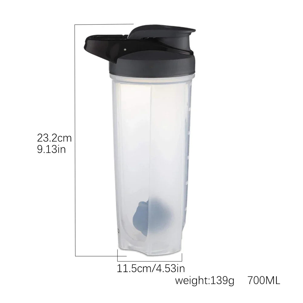 The 28 oz Shaker Bottle for Protein Shakes is a transparent cup with a ball blender whisk, black flip-top lid, handle, clear measurement markings, and is chemical-free. It stands 23.2 cm tall and 11.5 cm wide, made in Mainland China.