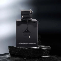 Armaf Night Club Wild Black Edition men's perfume bottle with leather fragrance spray on dark textured stone background